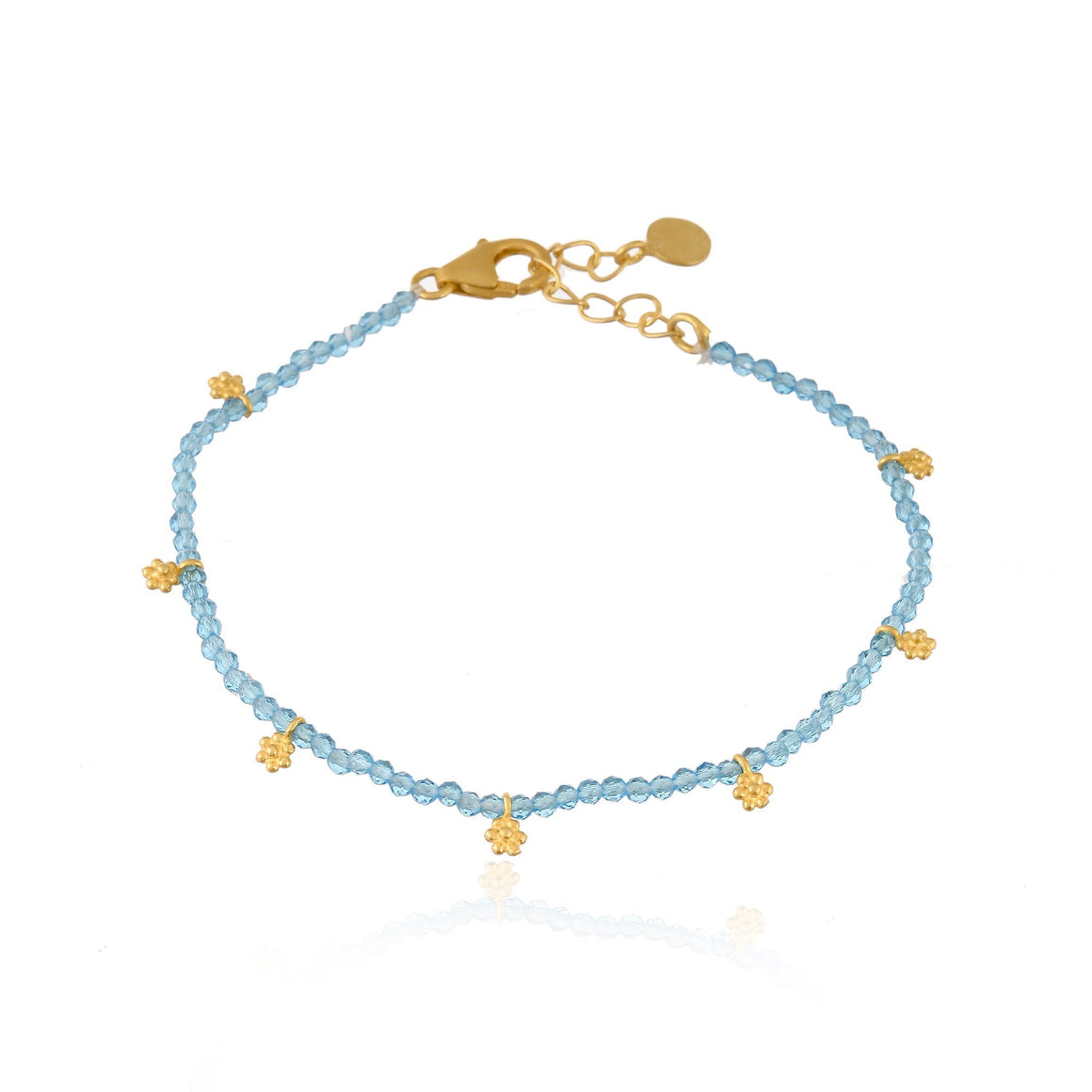 Blue Topaz beads with gold charms.